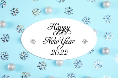 Image of Happy New 2022 Year! Beautiful baubles and snowflakes on light blue background, flat lay 