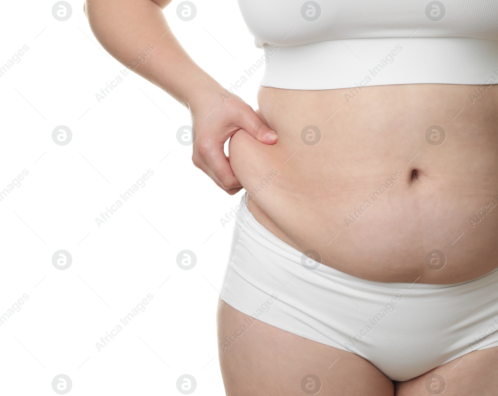 Photo of Woman touching belly fat on white background, closeup. Overweight problem