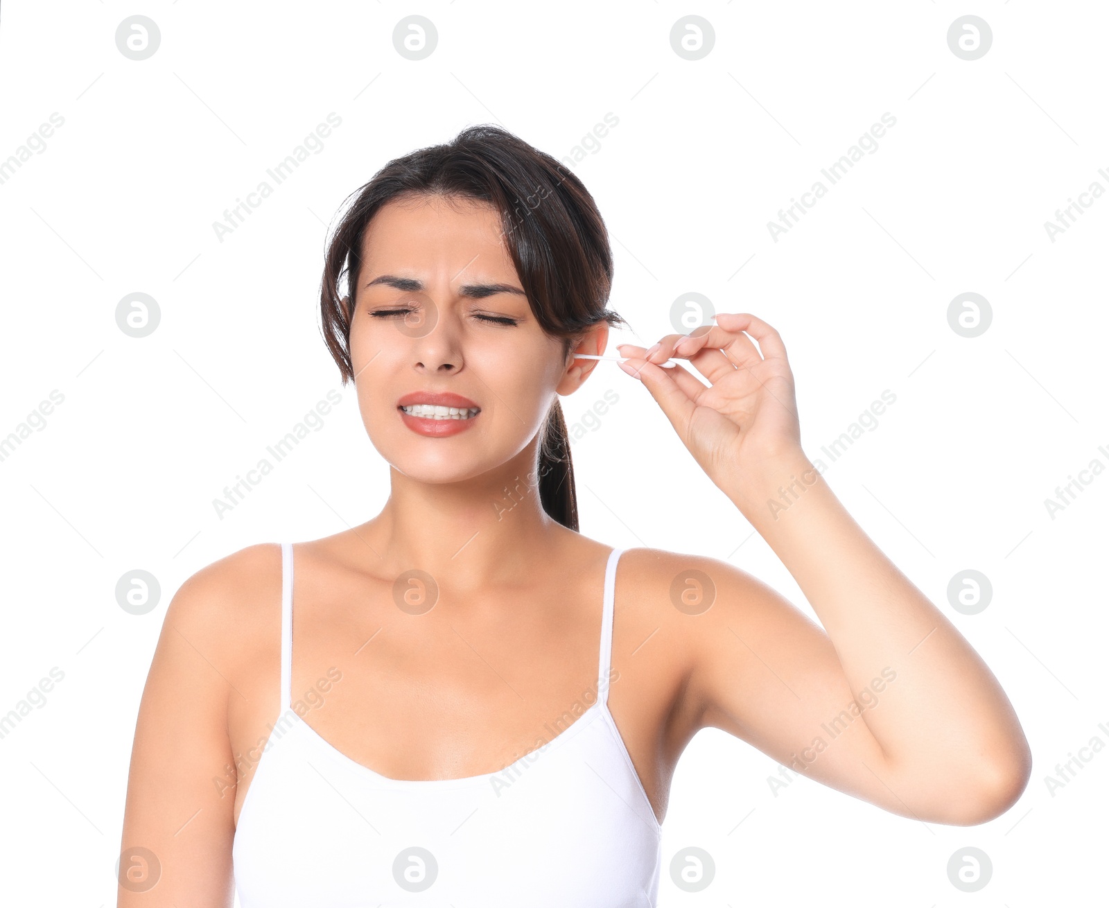 Photo of Young woman cleaning ear with cotton swab on white background