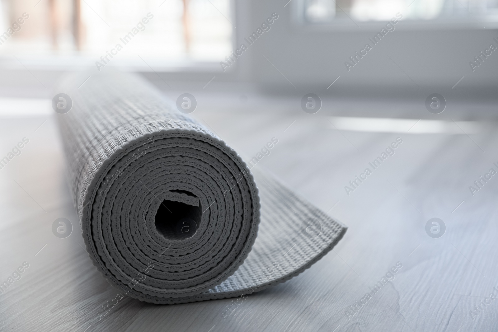 Photo of Karemat or fitness mat on floor, closeup. Space for text