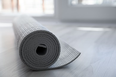 Photo of Karemat or fitness mat on floor, closeup. Space for text