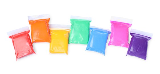 Photo of Many packages of different colorful plasticine on white background, top view