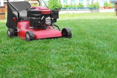 Photo of Modern garden lawn mower on green grass in park