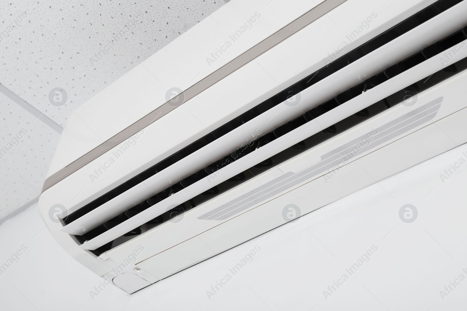 Photo of Modern air conditioner on white wall, closeup