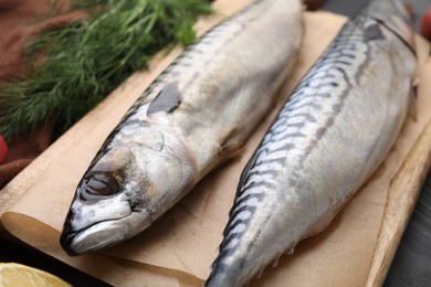 Photo of Two tasty salted mackerels on table, closeup