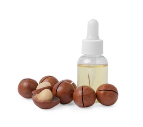 Photo of Delicious organic Macadamia nuts and natural oil isolated on white