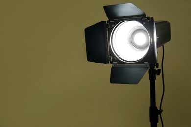 Photo of Modern spotlight against beige background, space for text