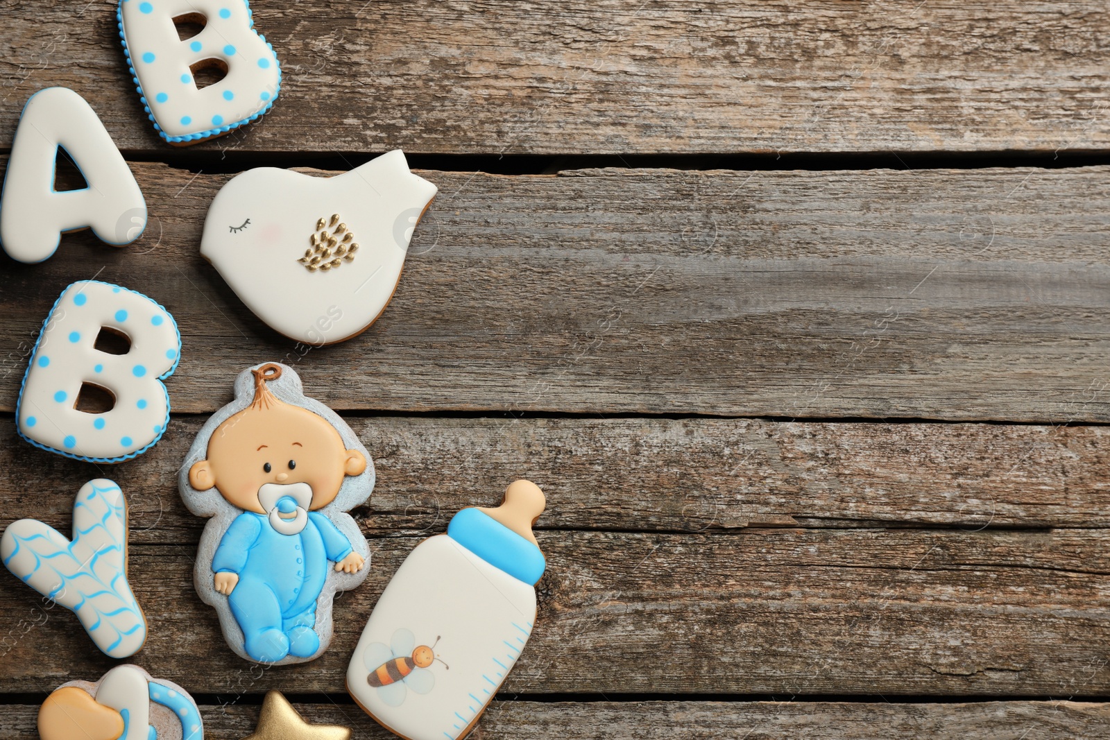 Photo of Word Baby and tasty cookies on wooden table, flat lay. Space for text