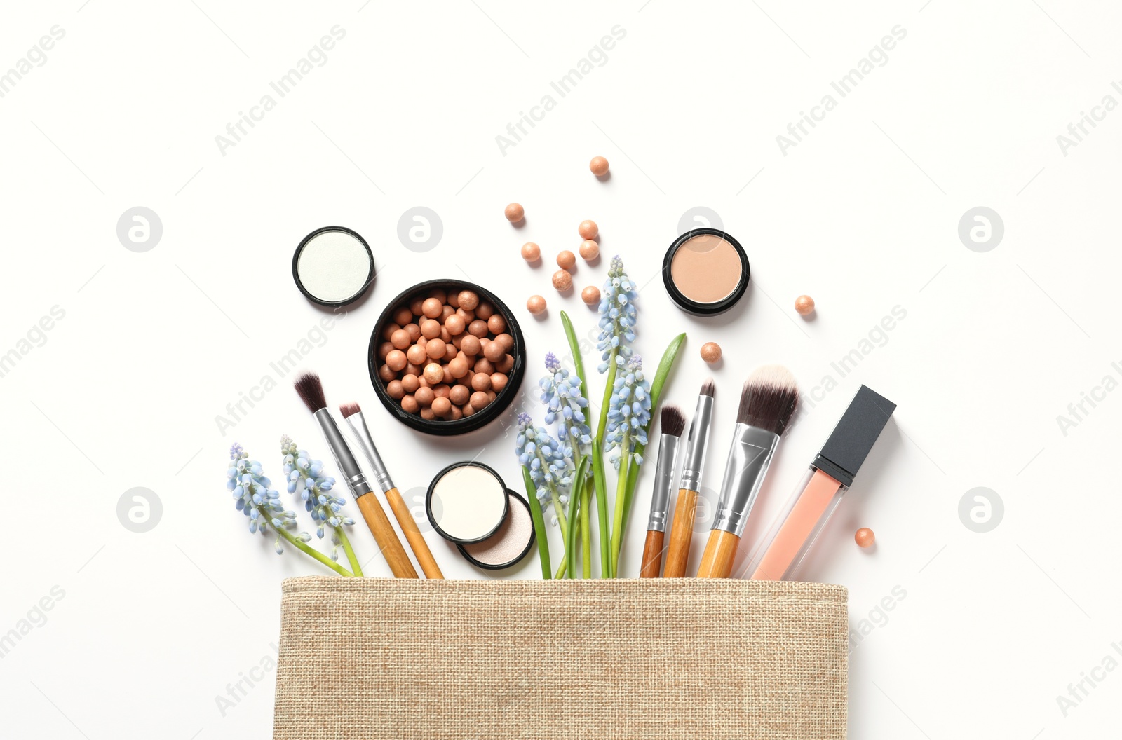 Photo of Makeup products and cosmetic bag on white background, top view