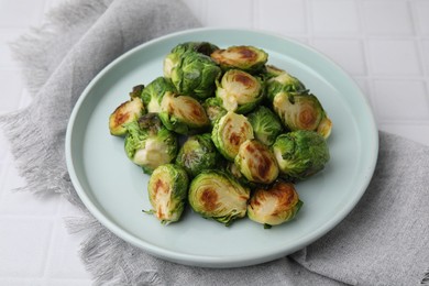 Delicious roasted Brussels sprouts on white tiled table