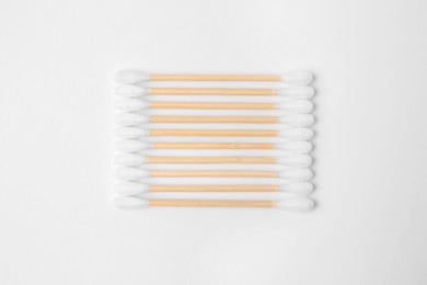 Photo of Many clean cotton buds isolated on white, top view