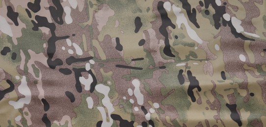 Photo of Texture of camouflage fabric as background, top view