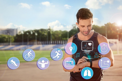 Man using smart watch during training outdoors. Icons near hand with device