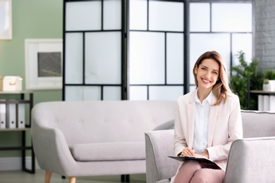 Photo of Young female psychologist in office