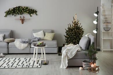 Photo of Stylish living room with Christmas decorations. Interior design