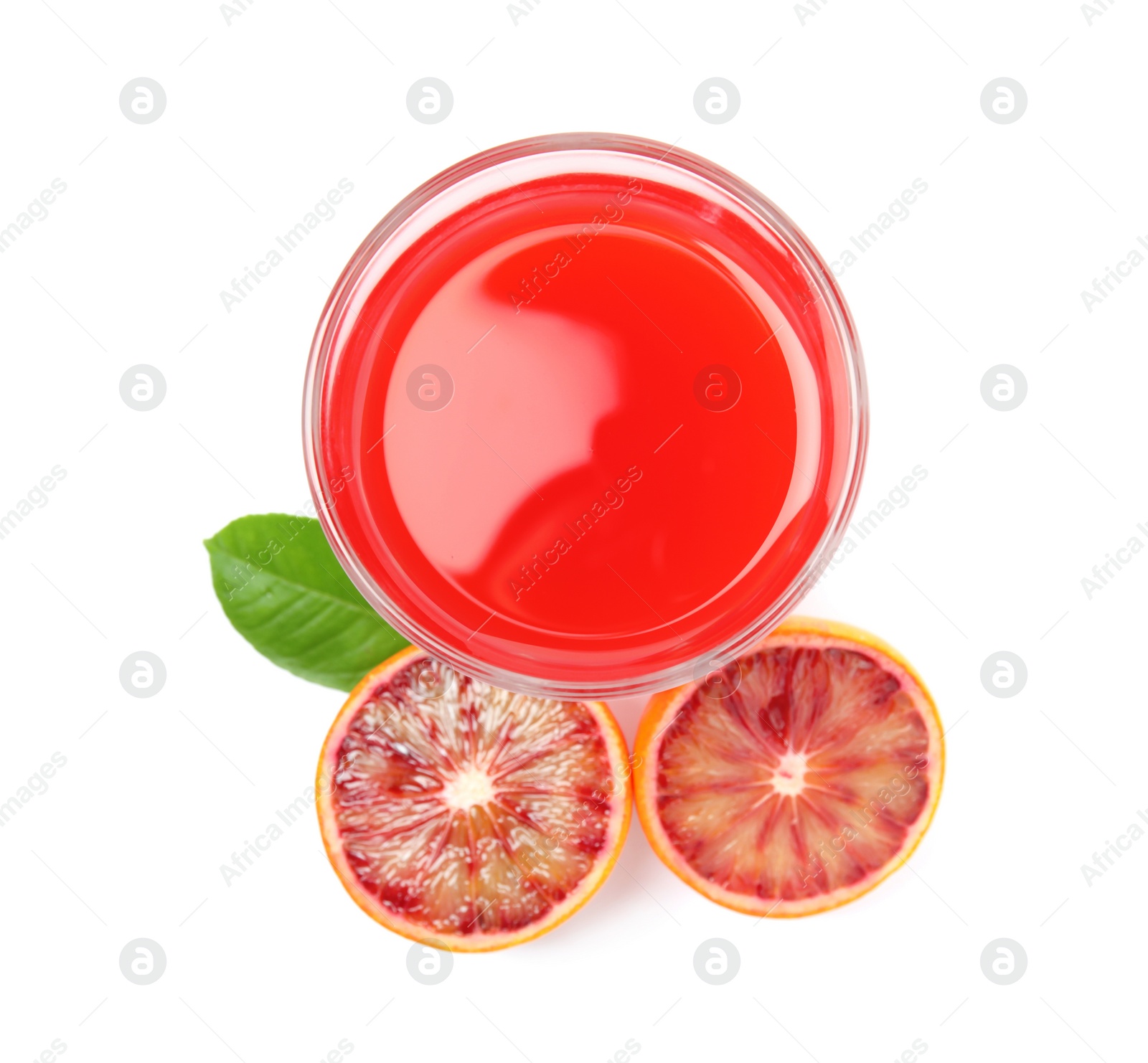 Photo of Tasty sicilian orange juice in glass, fruit and leaf on white background, top view