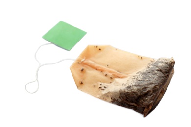 Photo of Used tea bag on white background. Aromatic drink