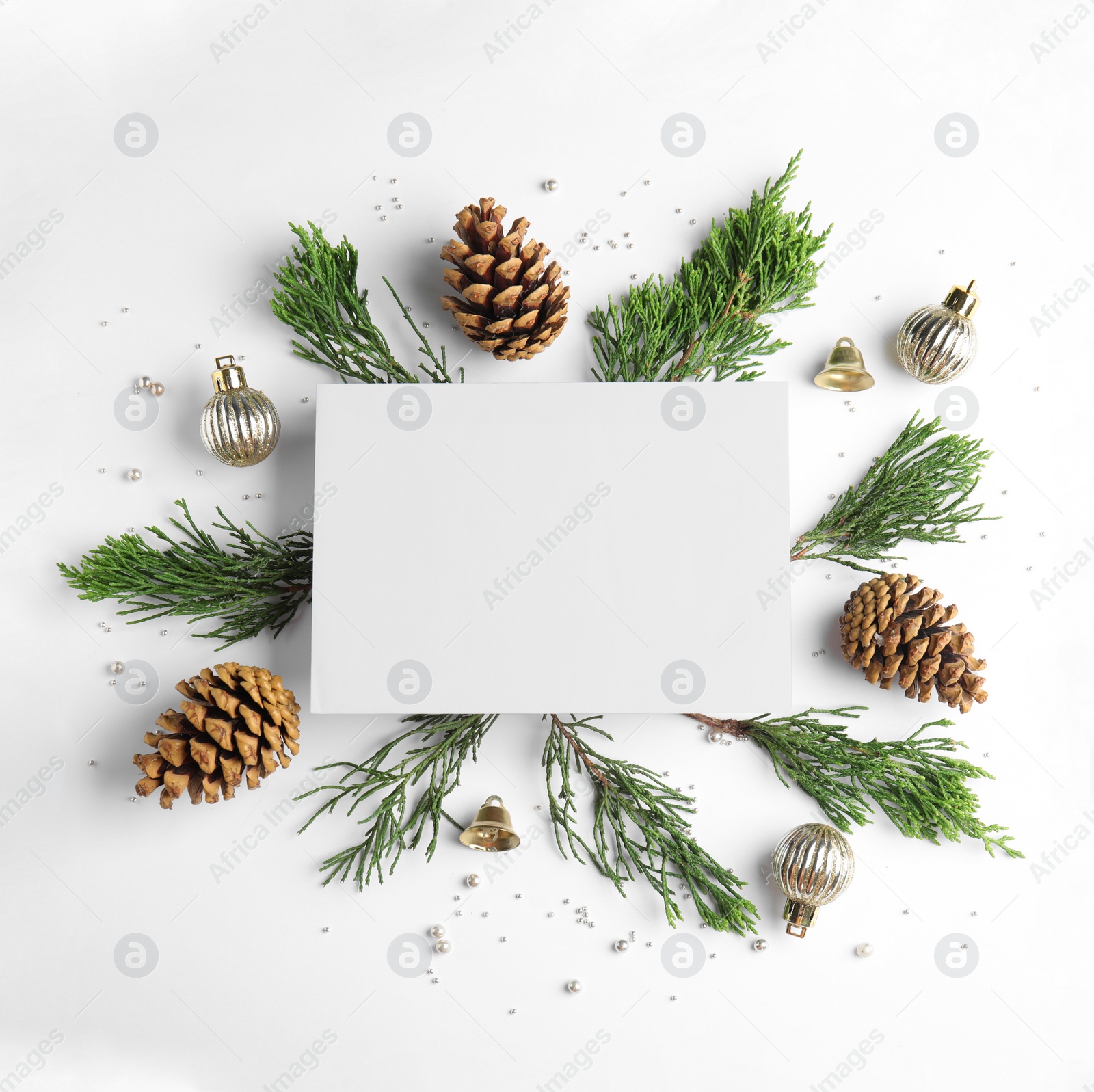 Photo of Composition with Christmas decor and blank card on white background, top view