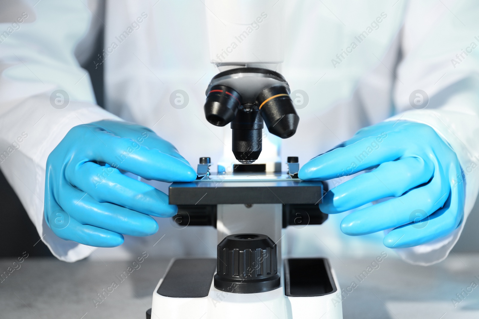 Photo of Scientist working with modern microscope, closeup. Chemical research