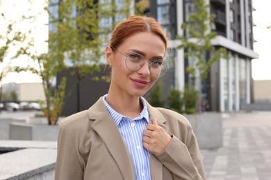 Portrait of beautiful woman in glasses outdoors