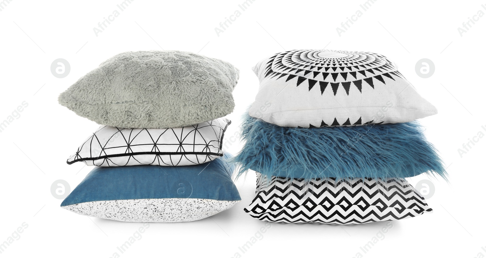 Photo of Stacks of different colorful pillows on white background