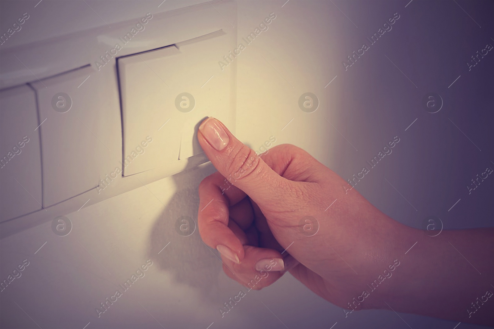 Photo of Woman turning off light switch indoors, closeup. Energy saving concept