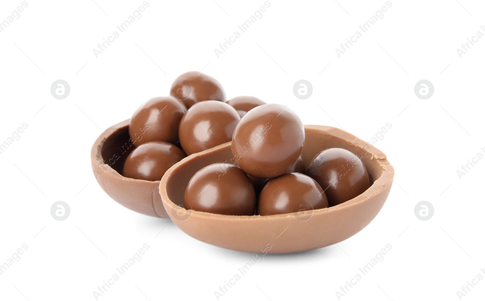 Photo of Halves of tasty chocolate egg with candies on white background