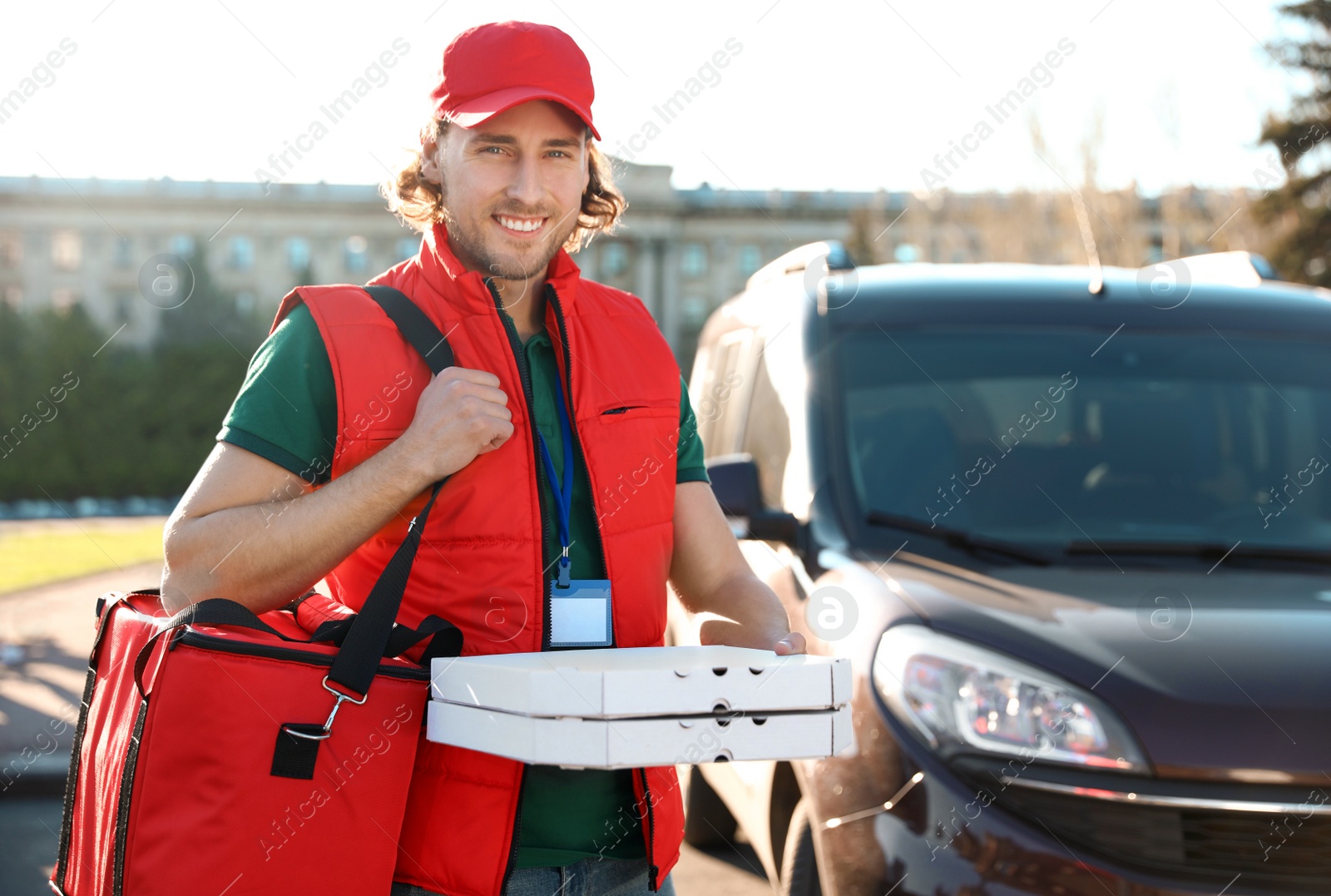 Photo of Male courier delivering food in city on sunny day