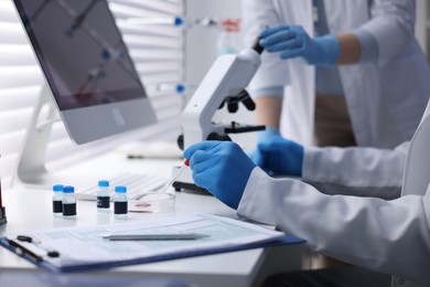 Photo of Scientists working with samples in laboratory, closeup. Medical research