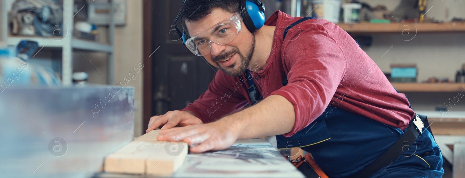 Image of Professional carpenter working machine at shop. Banner design