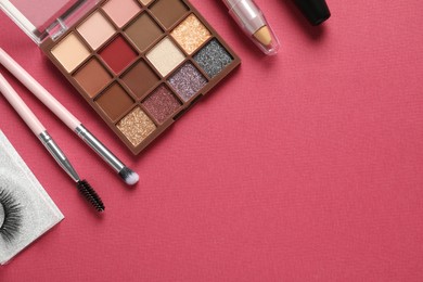 Set of makeup products on pink background, flat lay. Space for text