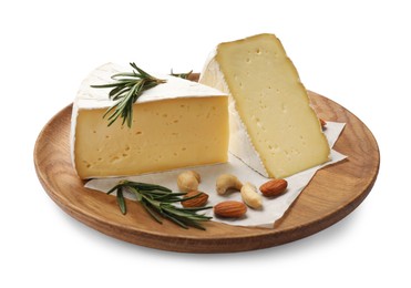 Plate with pieces of tasty camembert cheese, nuts and rosemary isolated on white