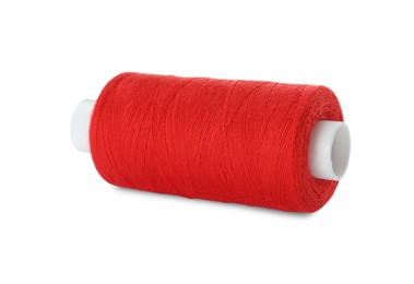 Photo of Spool of red sewing thread isolated on white