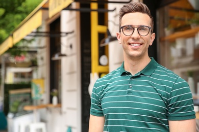 Photo of Portrait of attractive young man in stylish outfit outdoors