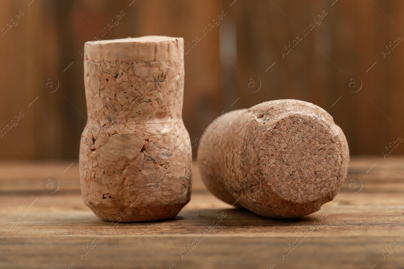 Photo of Corks of wine bottles on wooden table, closeup