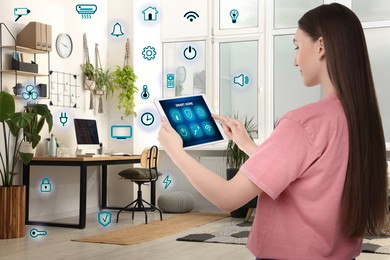 Image of Woman using smart home control system via application on tablet indoors. Different icons around her