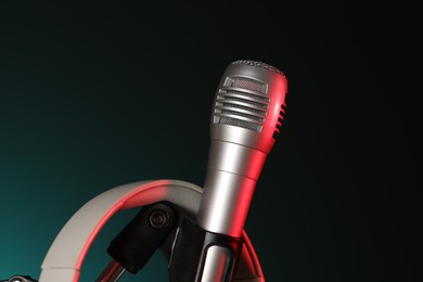 Photo of Stand with microphone on dark background, closeup. Sound recording and reinforcement