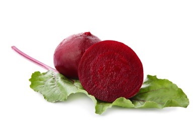 Photo of Whole and cut boiled red beets with green leaf on white background