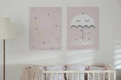 Stylish baby room interior with crib and cute wall art