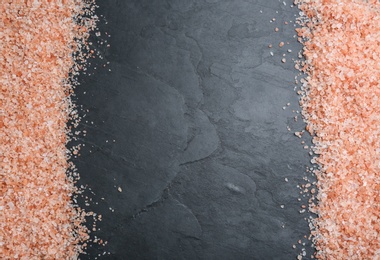 Photo of Frame of pink himalayan salt on black table, flat lay. Space for text