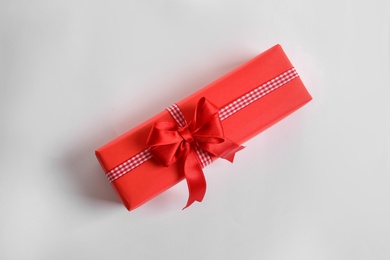 Beautifully wrapped gift box on white background, top view