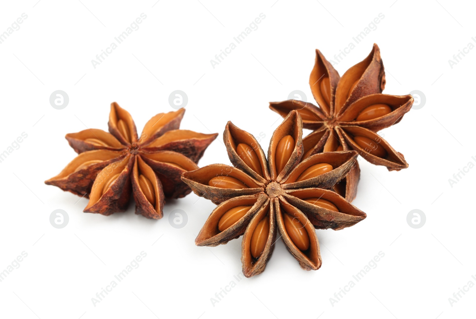 Photo of Dry anise stars with seeds on white background