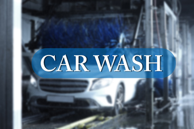 Image of Text Car Wash and modern automobile undergoing cleaning on background