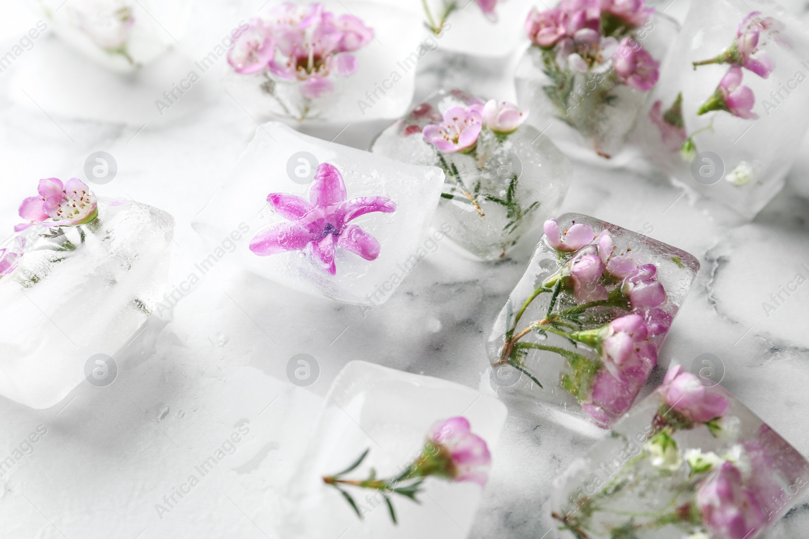 Photo of Floral ice cubes on marble table