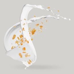 Image of Rolled oats and milk splash on grey background