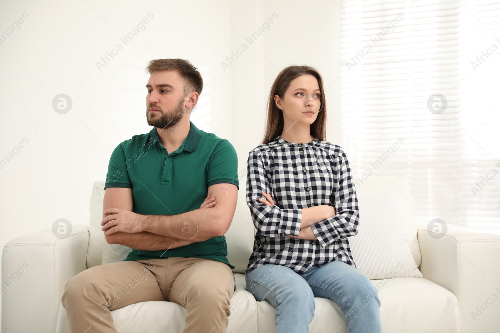Photo of Stubborn man and woman with problems in relationship at home