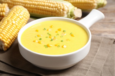 Photo of Delicious creamy corn soup on table, closeup