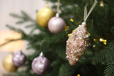 Photo of Beautiful Christmas balls hanging on fir tree, closeup. Space for text