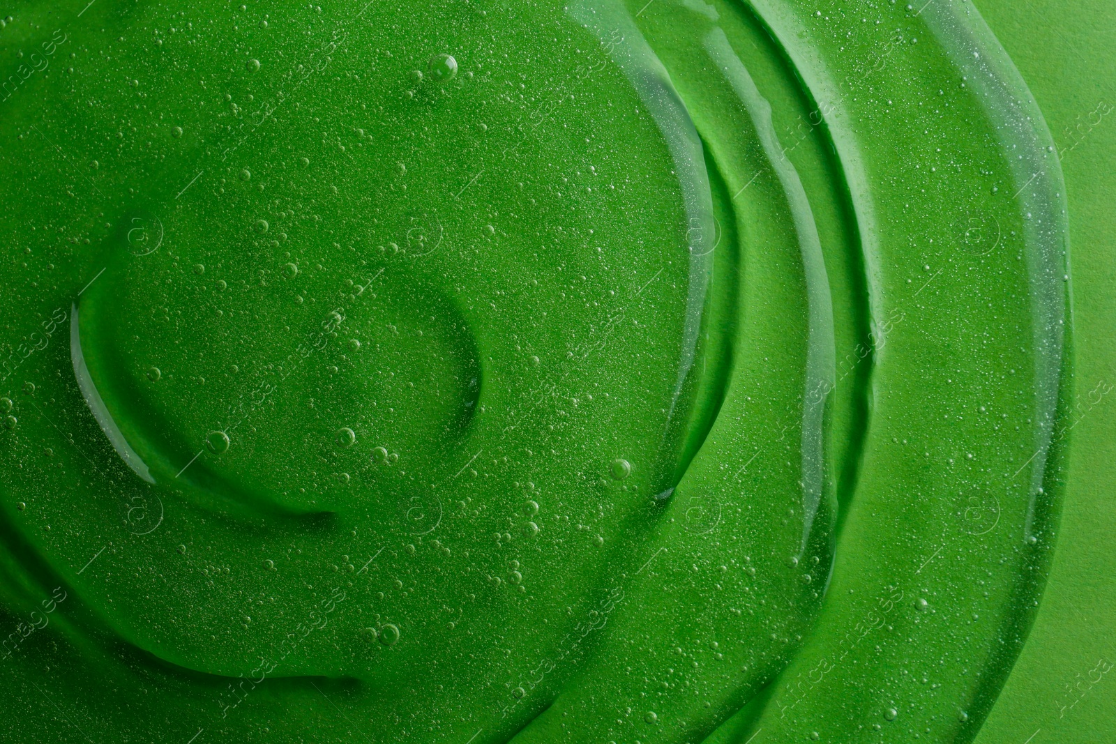 Photo of Texture of green shower gel as background, top view