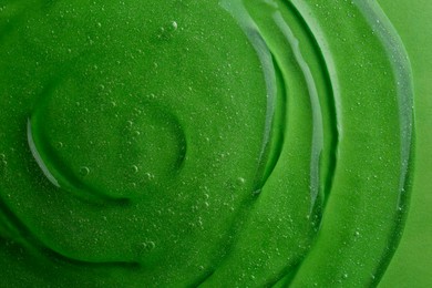 Photo of Texture of green shower gel as background, top view
